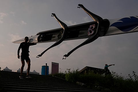 A rower carries a boat